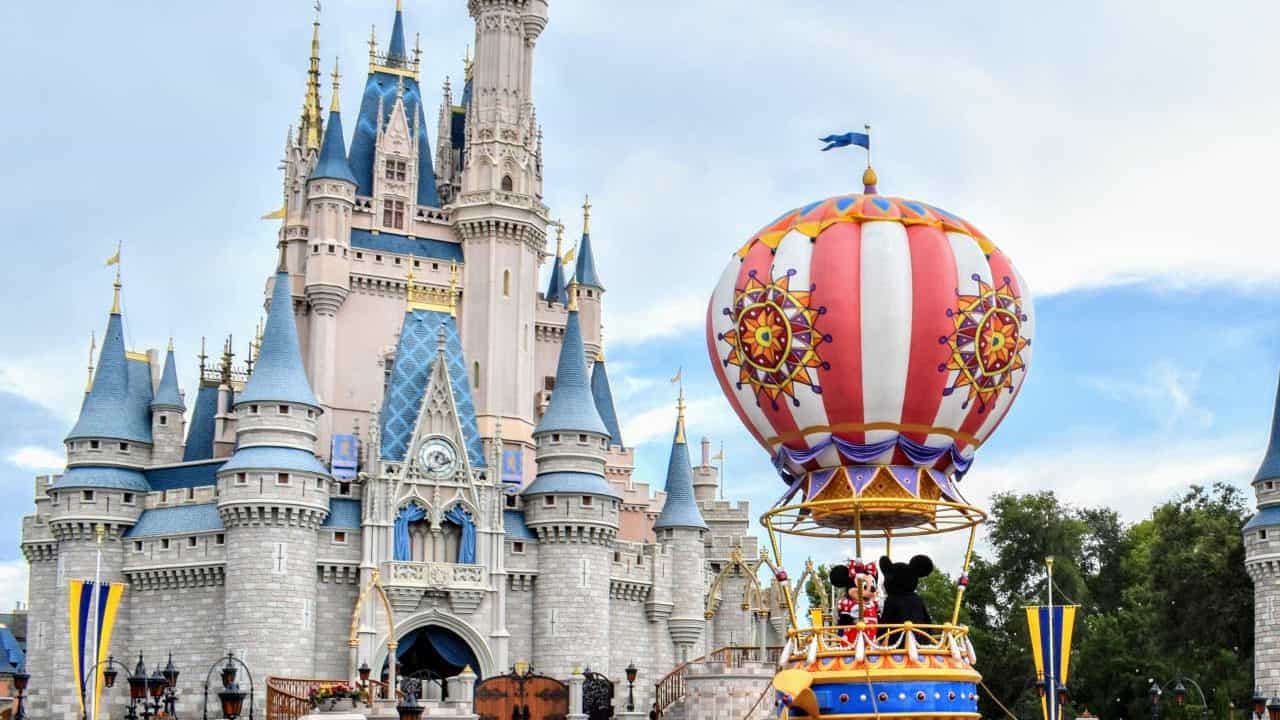 Festival of Fantasy Parade float with Mickey and Minnie in front of Cinderella Castle.