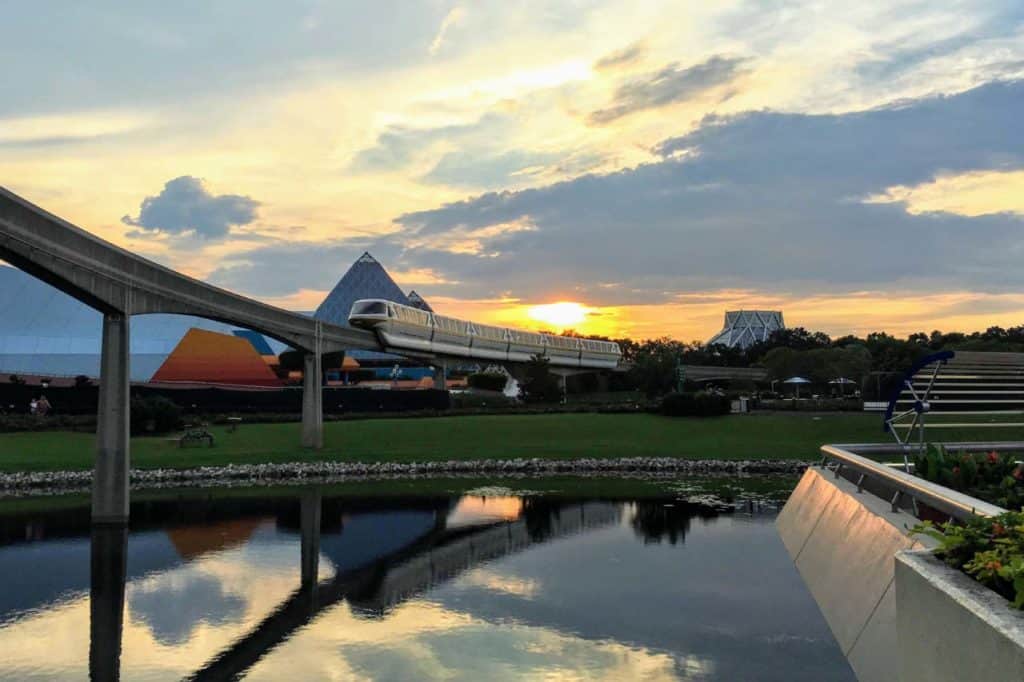 Sunset over the Imagination pavilion with Monorail Yellow passing through Epcot.